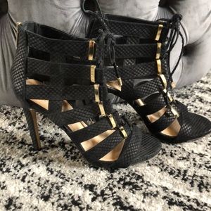 Vince Camuto black and gold cut out booties.